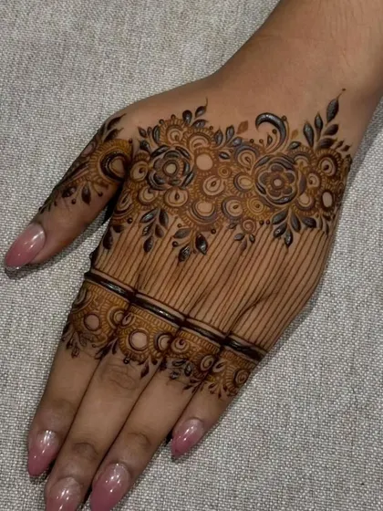 A close-up of a modern party-style design with a floral cuff and delicate lines on the palm.