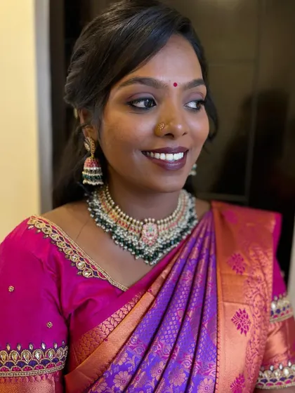 Priyanka smiling, showcasing her beautiful reception look. The airbrush makeup ensures a flawless finish that lasts all night.