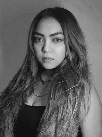 Focused, unbothered, glowing. A black and white portrait capturing a moment of inner peace and confidence.