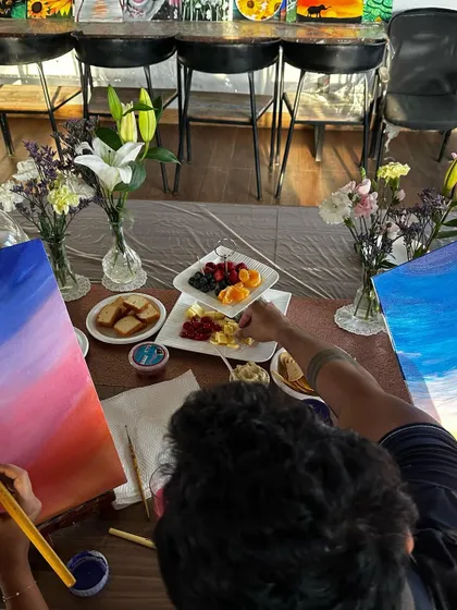 A guest enjoying the process of painting during the private birthday date. It's a wonderful way to relax, connect, and create something beautiful together.