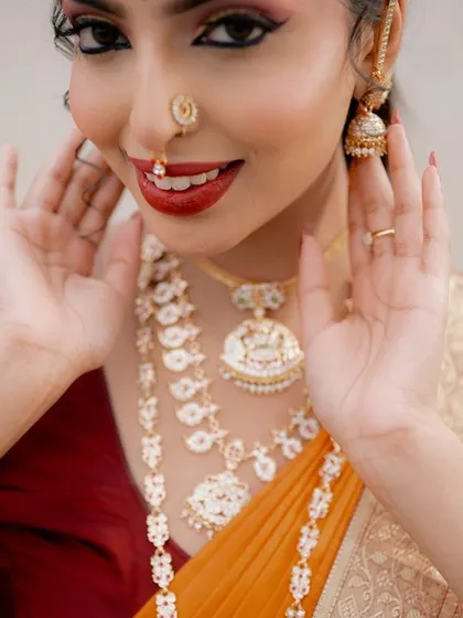 A close-up filled with personality. The bride's playful expression and gesture make this a lively and charming portrait that showcases her happiness.