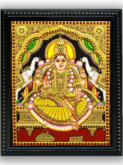 A beautiful Tanjore painting of Gaja Lakshmi, seated on a lotus with elephants on either side. This artwork is a classic symbol of wealth, fortune, and royalty, rendered in our signature style.