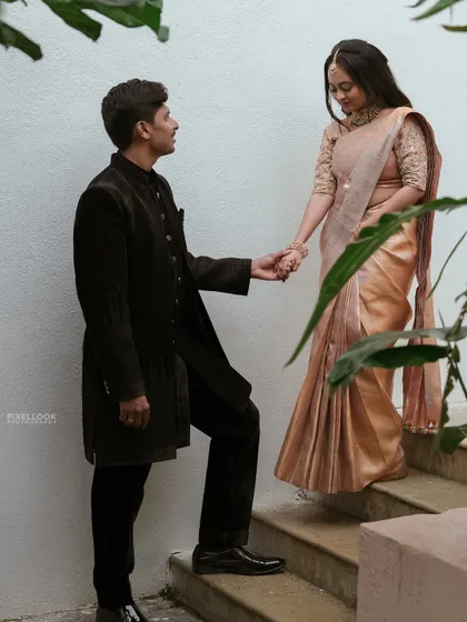 A candid moment on the stairs. The makeup looks beautiful in the soft, natural light, creating a dreamy and romantic feel.
