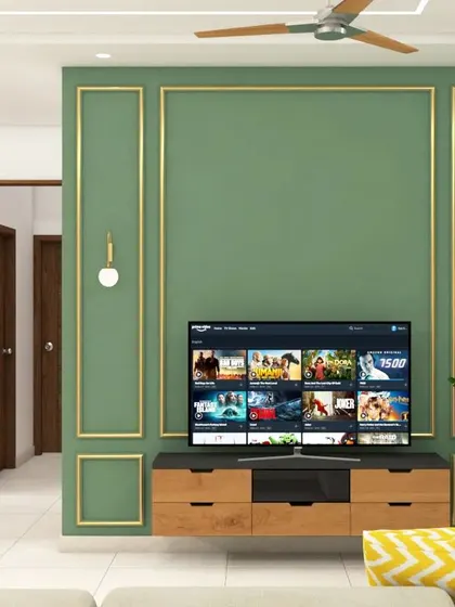 A classic living room TV wall painted in a deep sage green with elegant gold-colored beading for a touch of luxury. The floating wooden console provides ample storage and a clean, modern look.