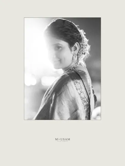An artistic black and white bridal portrait. The strong backlight creates a beautiful silhouette effect, while she gives a subtle glance towards the camera. It’s a simple, yet powerful and magical frame.