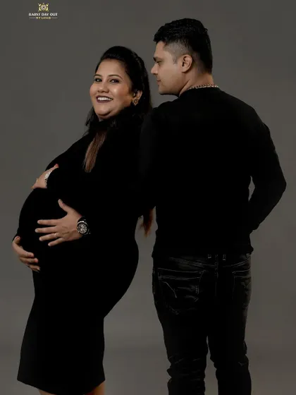 This is a duplicate of image 22, showing a candid and joyful moment captured in the studio. The mom-to-be's happy expression and the partner's loving gaze make this a truly special memory.