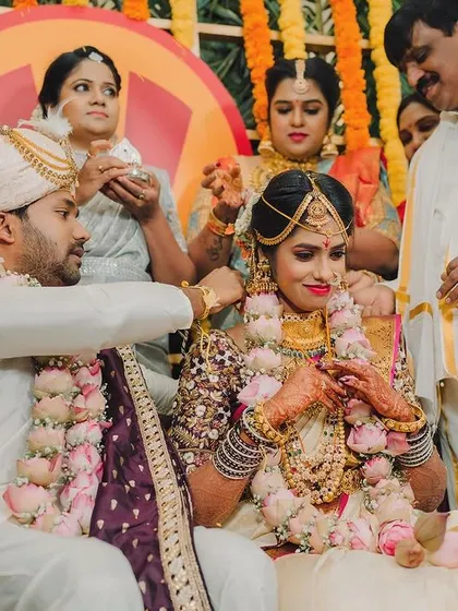 A beautiful moment from the wedding ceremony, capturing the couple surrounded by family and traditions.