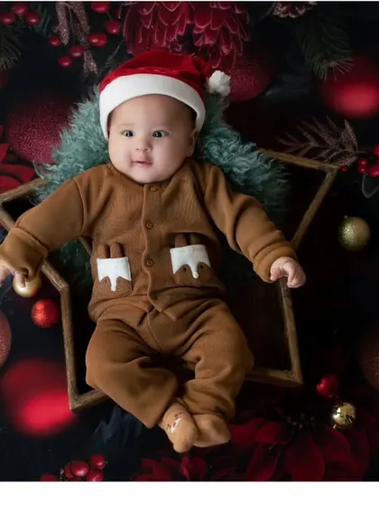 Our little gingerbread baby! This creative overhead shot is a fun and unique way to capture the Christmas spirit.