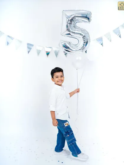 A classic birthday portrait with a balloon, capturing a simple and happy moment.