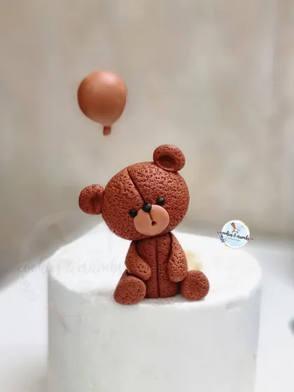 A close-up of the handmade fondant teddy bear topper. I love adding texture and small details to bring these little characters to life.