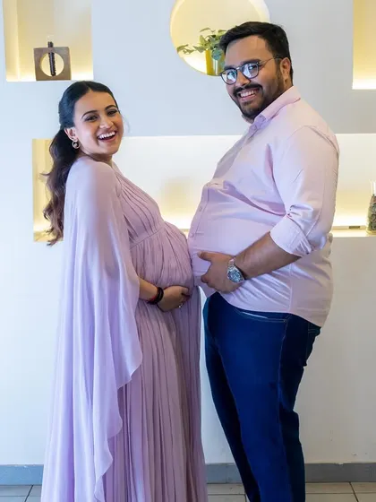 A fun photo with her husband, both showing off their bumps! These are the moments to treasure.