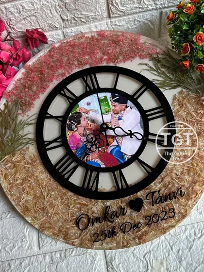 This angle shows how the central photo is perfectly framed by the black clock dial, creating a focal point amidst the preserved botanicals.
