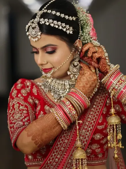 This stunning bride in her red lehenga is a perfect example of a classic North Indian bridal look. We focused on radiant skin, bold eyes, and a traditional bridal bun adorned with flowers.