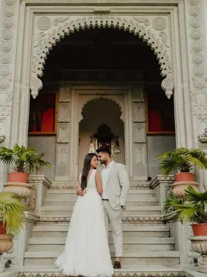 A majestic portrait in front of a heritage property. For destination weddings in places like Jaipur, we use the stunning architecture as a backdrop for regal photos.