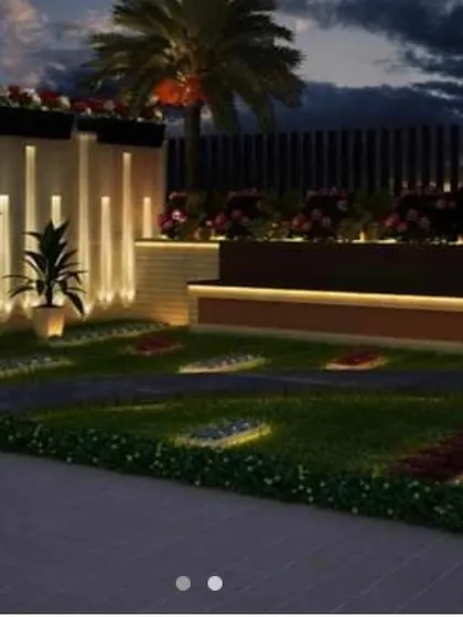 A modern backyard design featuring a raised wooden bench with under-lighting and a beautiful flower bed. The design uses clean lines and a combination of hardscape and softscape for a contemporary look.