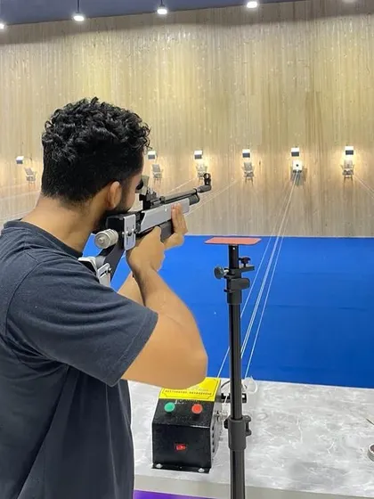 Talent hits a target no one else can. Here, a shooter practices at our well-lit indoor range, building the skills needed for precision.