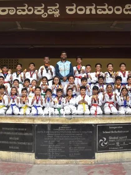 A large group photo of our students and instructors after a successful event. The mix of different colored belts on display shows the path of progression available to everyone at the academy.