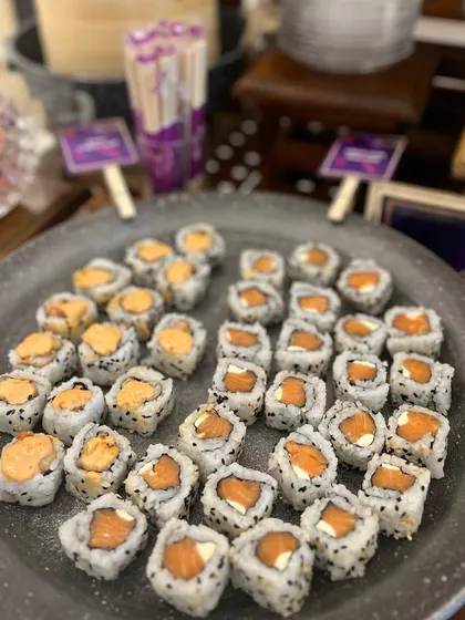 A platter of assorted sushi rolls ready for an event. I offer a variety of fillings and toppings to cater to different tastes, including vegetarian and non-vegetarian options.