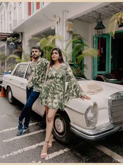 A full-length version of the stylish vintage car shot in Phuket, showcasing the couple's coordinated outfits and the cool, retro vibe.