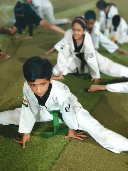 A young boy achieves a full split, a goal that takes months or even years of practice. I am incredibly proud of his dedication.