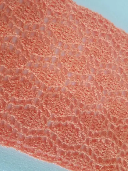 The light and breezy texture of the Sharad Ritu scarf is shown here. I used a DK weight yarn in a lovely peach color, perfect for a lightweight accessory.