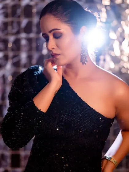 A glamorous one-shoulder sequin dress, captured with a strong backlight to create a star-like effect. This is a great example of a high-energy party or event look.
