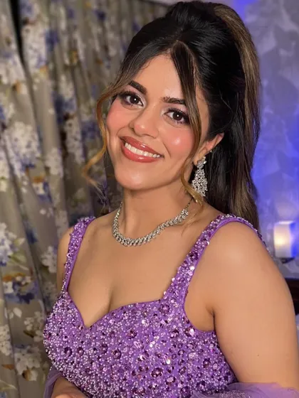A full smile showing off the complete look. The glowing skin and glossy lips are key features of this fresh and modern makeup style.