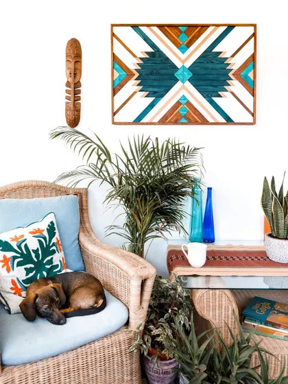 A repeat of a popular lifestyle shot, showing the blue Aztec art in a relaxed, plant-filled setting. It proves how one piece of art can define a space.