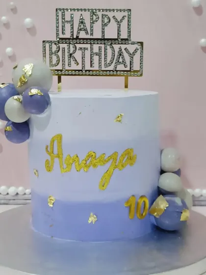 A lovely lavender-hued cake for a 10th birthday. The ombre effect and cascade of chocolate spheres create a modern and pretty design.