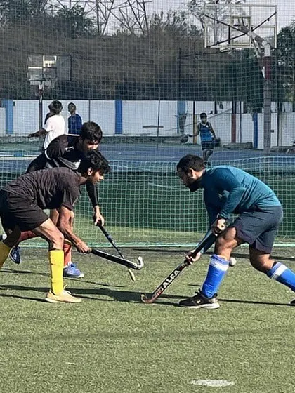 A defender puts pressure on the attacker, trying to win back possession. These competitive drills are key to developing resilient and effective players.