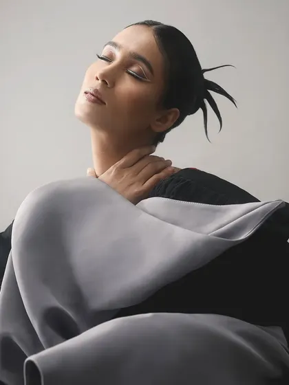 The dramatic pose and architectural clothing are perfectly balanced by the simple yet powerful white liner.