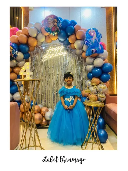This little girl is celebrating her 4th birthday in a Frozen-themed blue princess gown I created for her.