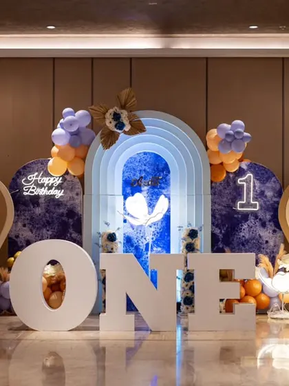 A wide shot of the luxurious hot air balloon first birthday setup. The scale of the 'ONE' letters and the elaborate backdrops create a truly memorable and grand statement.