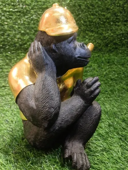 A side profile of the cool chimpanzee figurine, a quirky and unforgettable decor item.