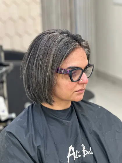 The final result of a salt-and-pepper blend. This sharp bob cut is enhanced by silver highlights that work with the client's natural grey hair for a chic look.