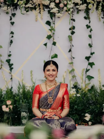 A beautiful portrait of the bride, Sonika. The backdrop of hanging ivy and delicate flowers creates a soft, romantic feel, highlighting the intricate details of our floral designs.
