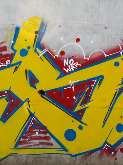 A close-up of the wildstyle lettering from the "No War" mural, showing the sharp angles and clean lines.