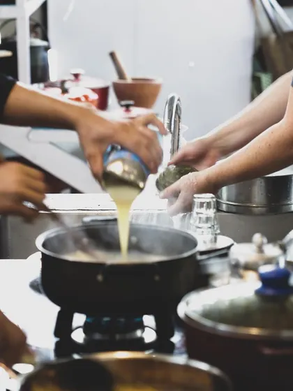Collaboration is key in a professional kitchen. Students work together, learning the flow and timing required to execute complex dishes.