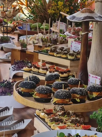This display features our popular black bun mini burgers alongside various canapés. The unique color of the buns always sparks conversation among guests.