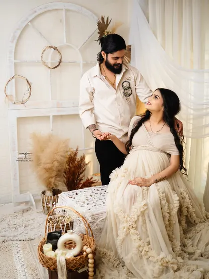 Belly full of love and dreams. This couple's portrait captures a quiet, loving gaze in the middle of our serene and earthy-toned boho studio setup.