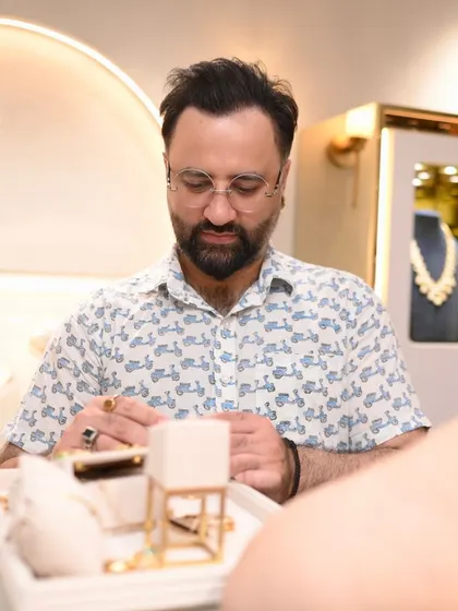 A guest carefully inspects a piece of jewelry at our New Delhi store. We encourage our clients to take their time and appreciate the fine craftsmanship of each item.