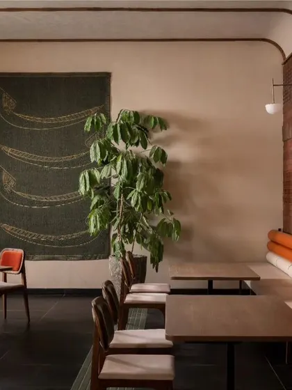 The interplay of different materials is key to our design. Here, the smooth plaster wall contrasts with the rough texture of the brick and the softness of the upholstered seating, creating a rich sensory experience.