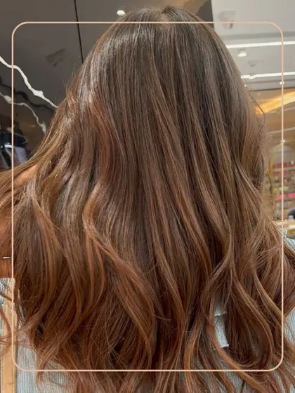 Warm, coppery tones styled into soft waves. This look is perfect for adding richness and vibrancy, and it glows beautifully in the light.