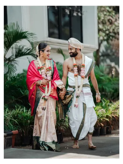 A full-length shot of the couple walking hand-in-hand, a timeless and classic wedding portrait.