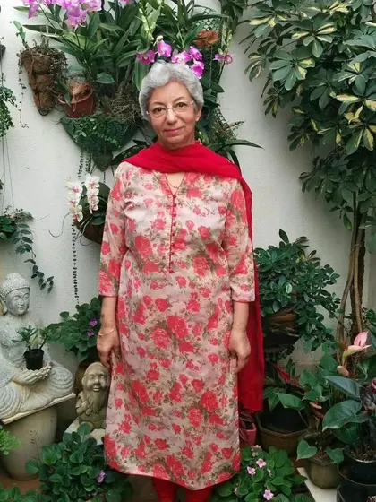 A member of our plant parent community surrounded by her beautiful garden, featuring a stunning collection of orchids. Gardening is a wonderful way to practice self-care and connect with nature.