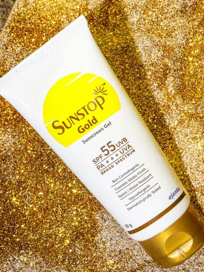 To highlight the 'Gold' in this sunscreen's name, I photographed the tube on a bed of gold glitter. This creative choice makes the product look luxurious and eye catching.