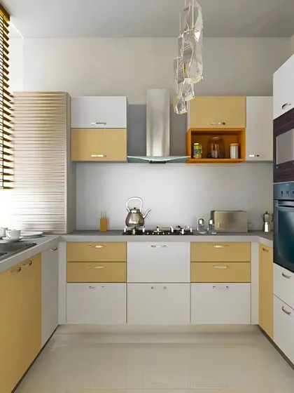 A U-shaped kitchen in a warm, creamy yellow and white palette. The design includes a tall unit with integrated ovens and makes excellent use of natural light from the window.
