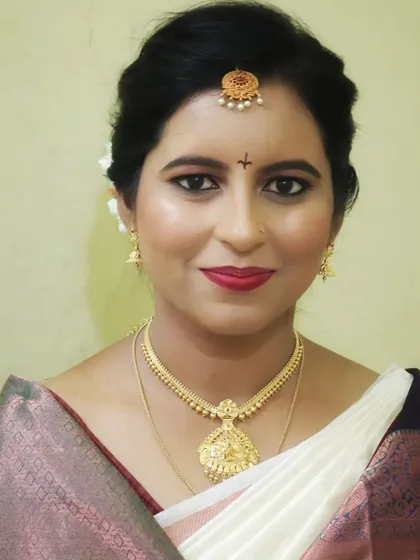 A close-up of a beautiful bride. Her makeup is fresh and glowing, with soft eye makeup and a bright lip color that enhances her natural beauty.