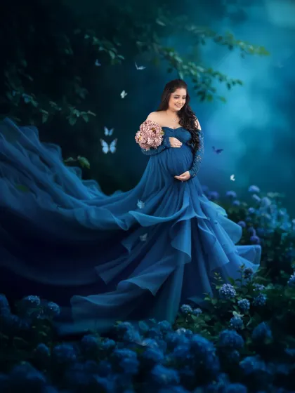 This is the kind of magic I love to create. We found the perfect flowing blue gown from my studio collection and created this dreamy, fairytale moment to celebrate her pregnancy glow. It’s all about making you feel absolutely beautiful.