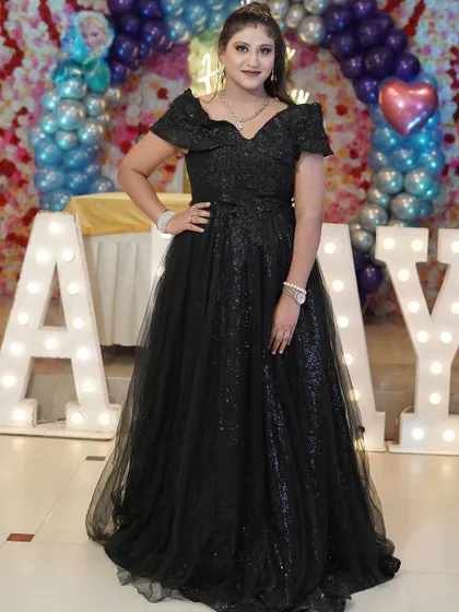 Our happy client celebrating her birthday in our sparkling black off-shoulder gown. It's the perfect party dress for any special occasion.